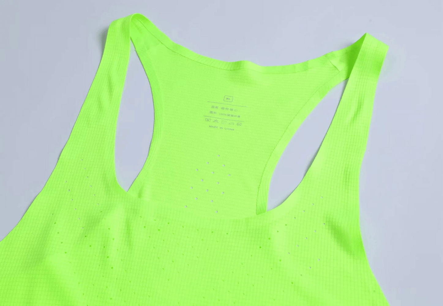 Vibrant color breathable men's tank top with perforated design for optimal airflow, perfect for athletic fit and workout sessions.